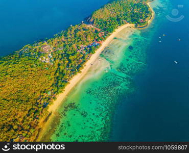 Aerial view of Phi Phi, Maya beach with blue turquoise seawater, mountain hills, and tropical green forest trees at sunset with Andaman sea in Phuket island in summer, Thailand in travel trip. Nature.