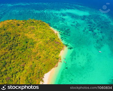 Aerial view of Phi Phi, Maya beach with blue turquoise seawater, mountain hills, and tropical green forest trees at sunset with Andaman sea in Phuket island in summer, Thailand in travel trip. Nature.