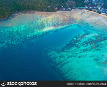 Aerial view of Phi Phi, Maya beach with blue turquoise seawater, mountain hills, and tropical green forest trees at sunset with Andaman sea in Phuket island in summer, Thailand in travel trip. Nature.