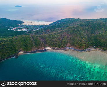 Aerial view of Phi Phi, Maya beach with blue turquoise seawater, mountain hills, and tropical green forest trees at sunset with Andaman sea in Phuket island in summer, Thailand in travel trip. Nature.