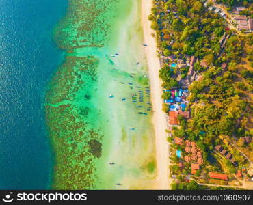 Aerial view of Phi Phi, Maya beach with blue turquoise seawater, mountain hills, and tropical green forest trees at sunset with Andaman sea in Phuket island in summer, Thailand in travel trip. Nature.