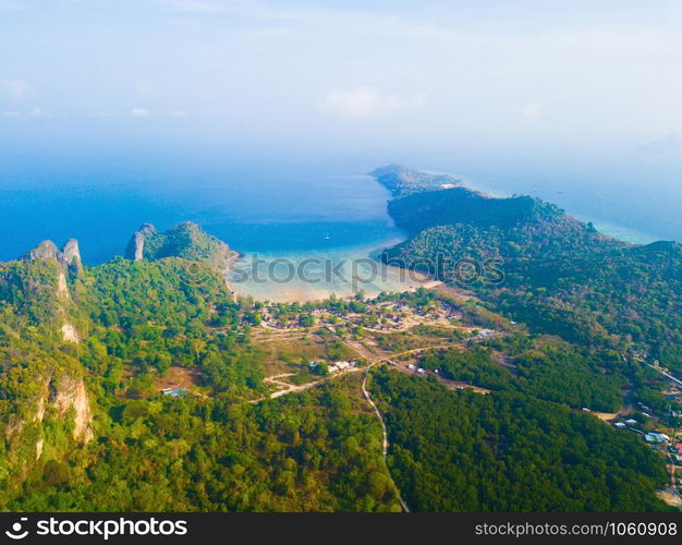 Aerial view of Phi Phi, Maya beach with blue turquoise seawater, mountain hills, and tropical green forest trees at sunset with Andaman sea in Phuket island in summer, Thailand in travel trip. Nature.