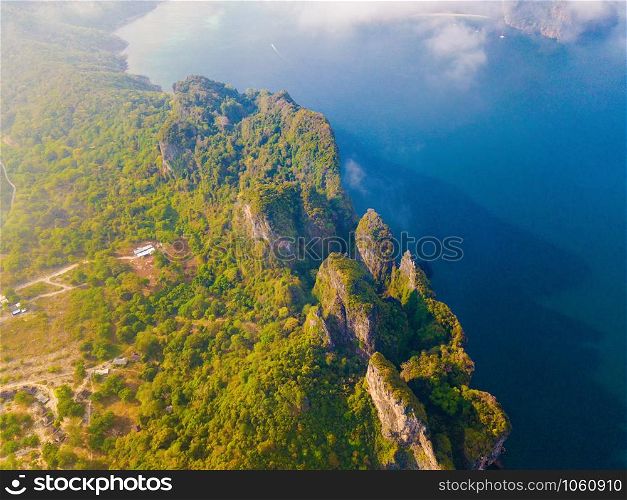 Aerial view of Phi Phi, Maya beach with blue turquoise seawater, mountain hills, and tropical green forest trees at sunset with Andaman sea in Phuket island in summer, Thailand in travel trip. Nature.