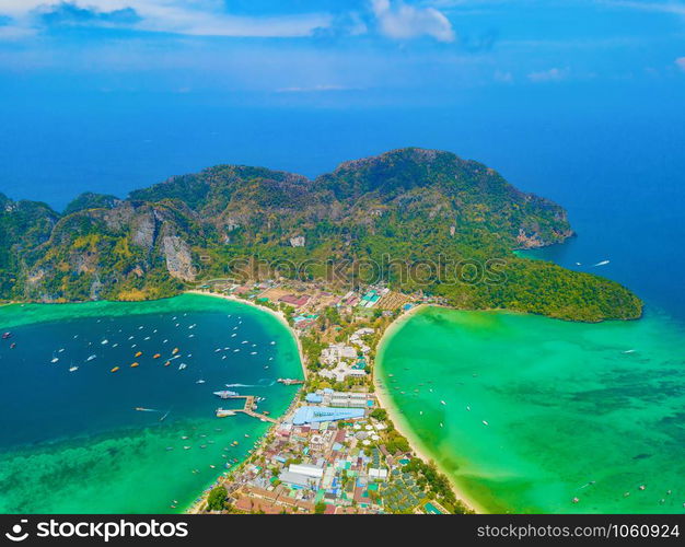 Aerial view of Phi Phi, Maya beach with blue turquoise seawater, mountain hills, and tropical green forest trees at sunset with Andaman sea in Phuket island in summer, Thailand in travel trip. Nature.