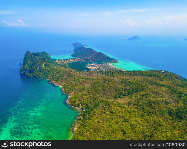 Aerial view of Phi Phi, Maya beach with blue turquoise seawater, mountain hills, and tropical green forest trees at sunset with Andaman sea in Phuket island in summer, Thailand in travel trip. Nature.