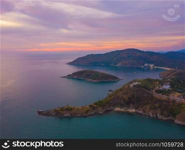Aerial view of Promthep Cape viewpoint at sunset with Andaman sea in Phuket Island, tourist attraction in Thailand in travel trip and holidays vacation. Natural landscape wallpaper background.