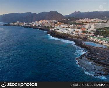 Aerial view of Puerto de Santiago coastline in Tenerife from drone.