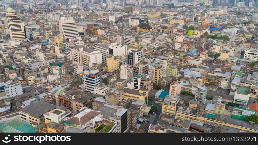 Aerial view of residential buildings and traditional temple in Rattanakosin Island, Bangkok downtown at sunset, Thailand. Urban city in Asia. Architecture landscape background.