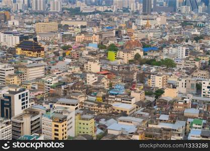 Aerial view of residential buildings and traditional temple in Rattanakosin Island, Bangkok downtown at sunset, Thailand. Urban city in Asia. Architecture landscape background.