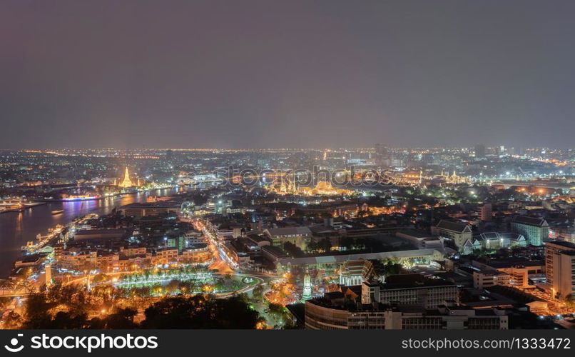 Aerial view of residential buildings and traditional temple in Rattanakosin Island, Bangkok downtown at night, Thailand. Urban city in Asia. Architecture landscape background.