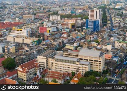 Aerial view of residential buildings and traditional temple in Rattanakosin Island, Bangkok downtown at sunset, Thailand. Urban city in Asia. Architecture landscape background.