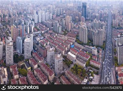 Aerial view of residential houses with skyscraper and high-rise buildings in Shanghai Downtown, China. Financial district and business centers in smart city in Asia.