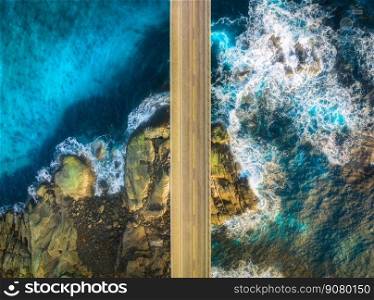 Aerial view of road, sea with waves and stones at sunset in Lofoten Islands, Norway. Landscape with beautiful bridge, transparent blue water, rocks. Top view from drone of highway in summer. Travel