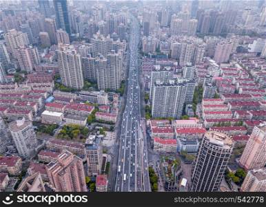 Aerial view of road with skyscraper and high-rise office buildings in Shanghai Downtown, China. Financial district and business centers in smart city in Asia.
