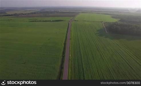 Aerial view of roads running through the vast green fields. Landscapes of Russia