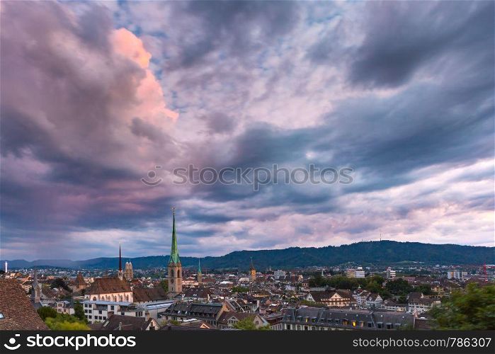 Aerial view of roofs and church towers in Old Town of Zurich, the largest city in Switzerland at sunset.. Zurich, the largest city in Switzerland