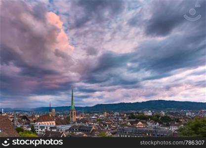 Aerial view of roofs and church towers in Old Town of Zurich, the largest city in Switzerland at sunset.. Zurich, the largest city in Switzerland