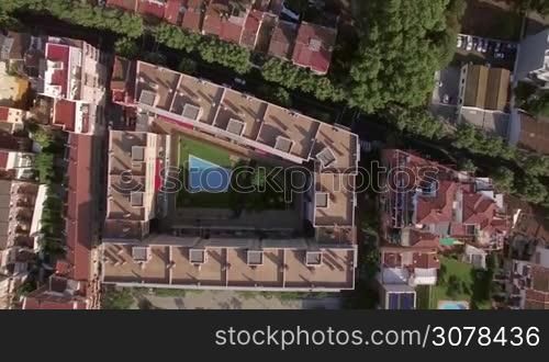 Aerial view of roofs of buildings and hotels with swimming pools, gardens, trees, Barcelona, Spain