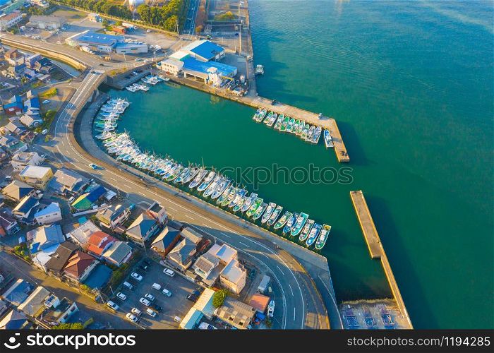 Aerial view of sail boats in marina port in harbor with blue turquoise seawater in urban city or town, Japan in travel trip and transportation concept. Top view.