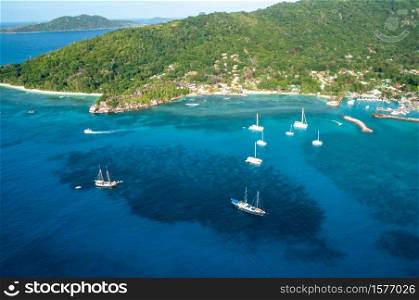 Aerial view of Sailing boats from above over a blue water