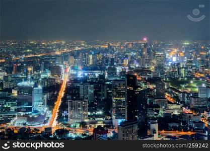 Aerial view of Sathorn, Bangkok Downtown. Financial district and business centers in smart urban city in Asia. Skyscraper and high-rise buildings at night.