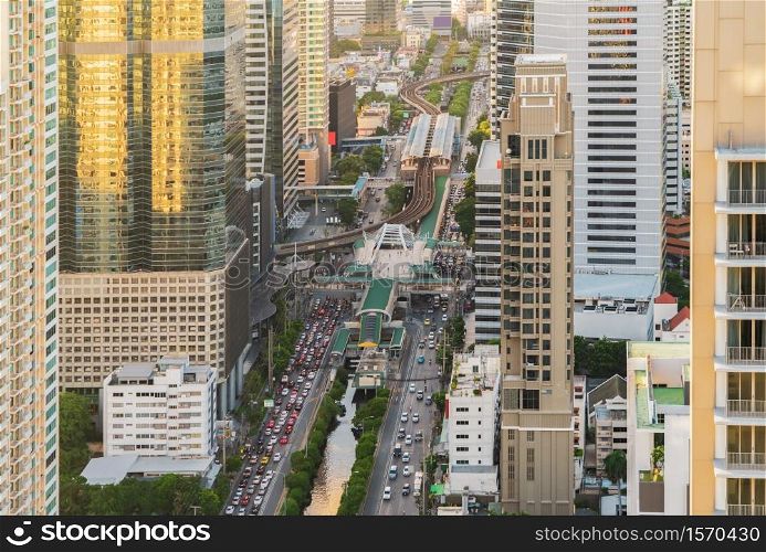 Aerial view of Sathorn intersection or junction with cars traffic, Bangkok Downtown. Thailand. Financial district in smart urban city and technology concept. Skyscraper office buildings.