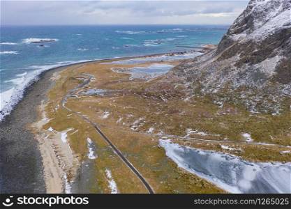 Aerial view of seascape at Skagsanden beach in Lofoten islands, Nordland county, Norway, Europe. Nature landscape background in winter season. Famous tourist attraction. Sunset sky