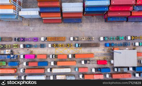 Aerial view of semi truck and trailer loading at logistic center, Business freight shipping import export transportation by semi truck trailer vehicle.