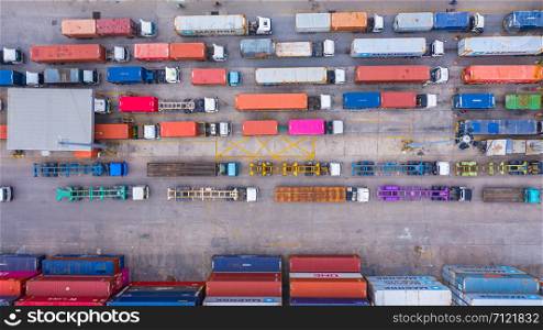 Aerial view of semi truck and trailer loading at logistic center, Business freight shipping import export transportation by semi truck trailer vehicle.