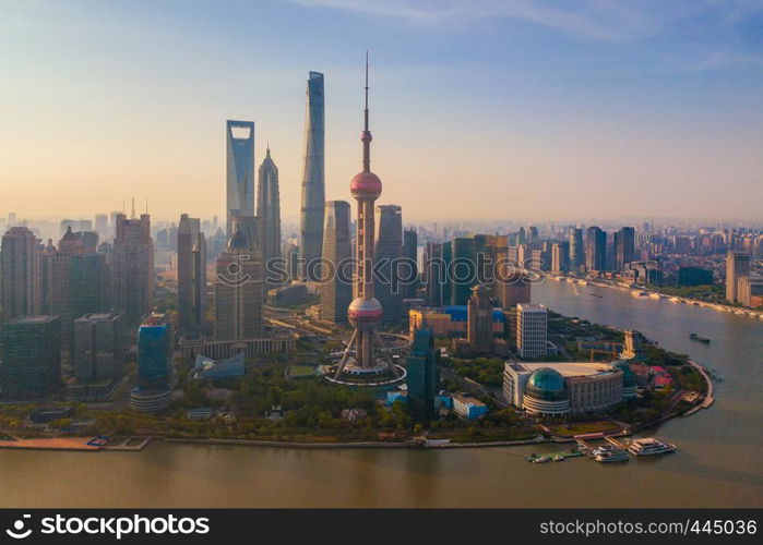 Aerial view of Shanghai Downtown, China. Financial district and business centers in smart city in Asia. Top view of skyscraper and high-rise buildings at sunset.