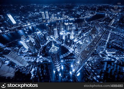 Aerial view of Shanghai Downtown, China. Financial district and business centers in smart city in Asia. Top view of skyscraper and high-rise buildings at night.