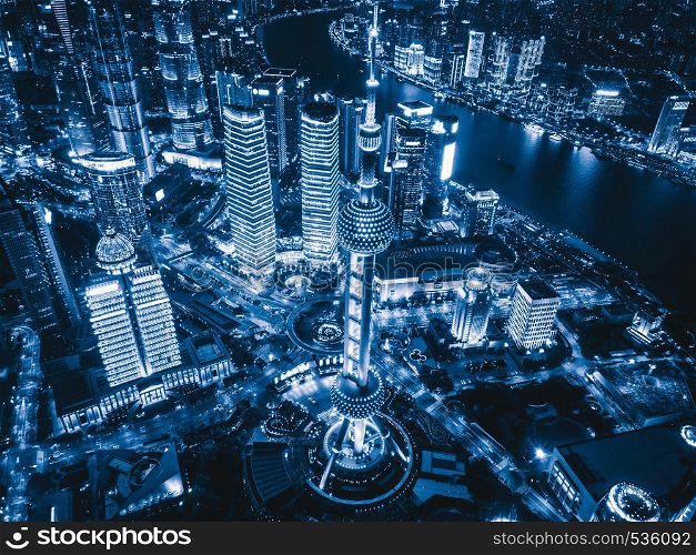 Aerial view of Shanghai Downtown, China. Financial district and business centers in smart city in Asia. Top view of skyscraper and high-rise buildings at night.