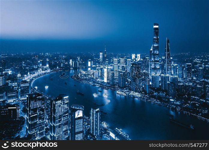 Aerial view of Shanghai Downtown, China. Financial district and business centers in smart city in Asia. Skyscraper and high-rise buildings at night.