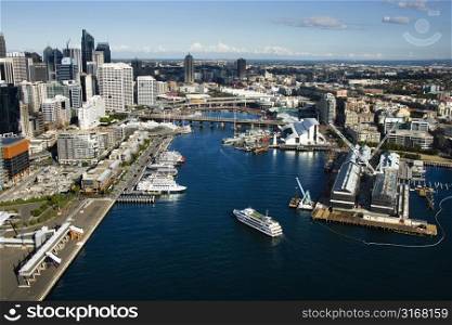 Aerial view of ships and boats in Darling Harbour with view of skyscrapers in Sydney, Australia.