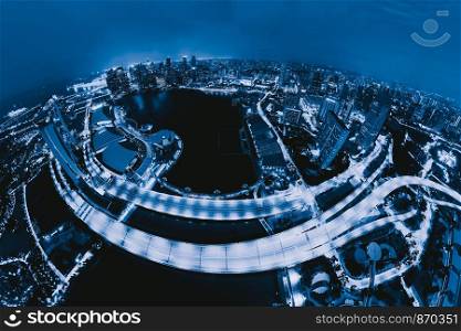 Aerial view of Singapore Downtown. Financial district and business centers in technology smart urban city in Asia. Skyscraper and high-rise buildings at night.