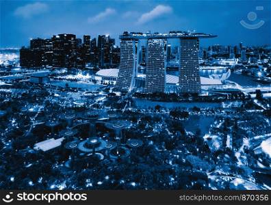 Aerial view of Singapore Downtown. Financial district and business centers in technology smart urban city in Asia. Skyscraper and high-rise buildings at night.