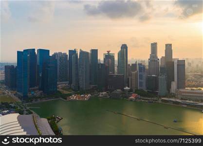 Aerial view of Singapore Downtown skyline at sunset. Financial district and business centers in technology smart urban city in Asia. Skyscraper and high-rise buildings.