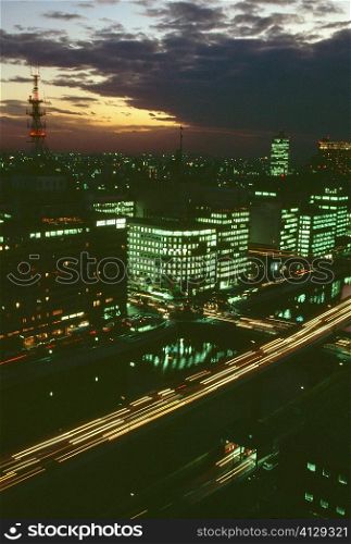 Aerial view of skyscrapers lit up at night, Osaka, Japan