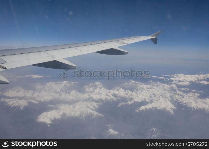 Aerial view of snow covered alps through airplane; France