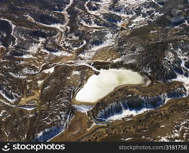 Aerial view of snow covered rural Colorado scenic with lake.
