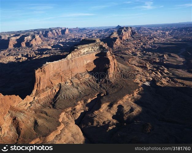 Aerial view of southwest desert with cliffs and rock formations.