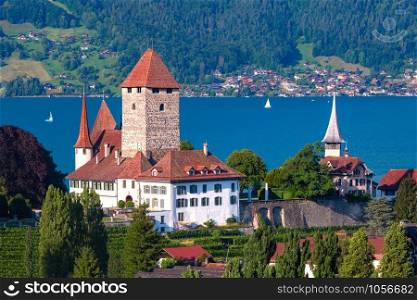 Aerial view of Spiez Church and Castle on the shore of Lake Thun in the Swiss canton of Bern at sunset, Spiez, Switzerland.. Spiez Church and Castle, Switzerland
