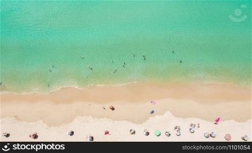 Aerial view of Surin beach, Phuket, Thailand, Surin beach is a very famous tourist destination in Phuket, Tropical sandy beach with turquoise clear water, Tourist on the beach and colorfull umbrellas.