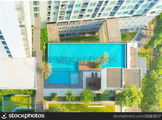 Aerial view of swimming pool on rooftop of hotel apartment building in Bangkok downtown skyline, urban city view. Relaxing in summer season in travel holiday vacation concept. Recreation lifestyle.