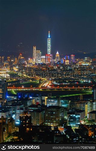 Aerial view of Taipei Downtown, Taiwan. Financial district and business centers in smart urban city. Skyscraper and high-rise buildings at night.