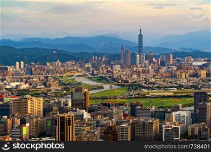Aerial view of Taipei Downtown, Taiwan. Financial district and business centers in smart urban city. Skyscraper and high-rise buildings at sunset.