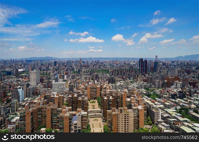 Aerial view of Taipei Downtown, Taiwan. Financial district and business centers in smart urban city. Skyscraper and high-rise buildings at noon.