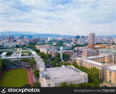 Aerial view of Taipei Downtown, Taiwan. Financial district and business centers in smart urban city. Skyscraper and high-rise buildings at noon with blue sky.