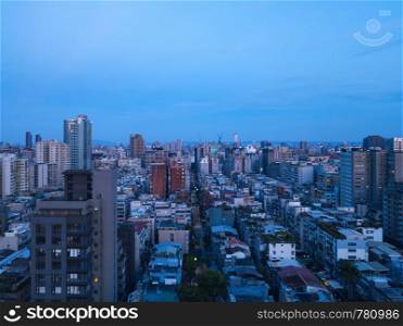 Aerial view of Taipei Downtown, Taiwan. Financial district and business centers in smart urban city. Skyscraper and high-rise buildings at night.