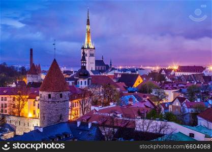 Aerial view of Tallinn Medieval Old Town illuminated in evening twilight, with dramatic sky Estonia. Tallinn Medieval Old Town, Estonia